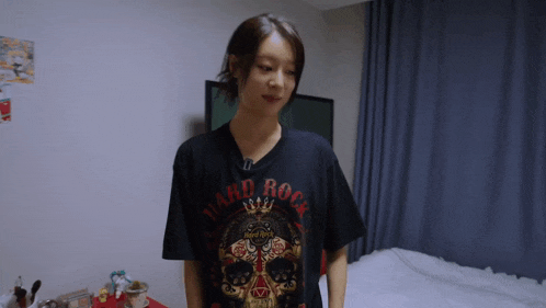 a woman is wearing a black hard rock shirt