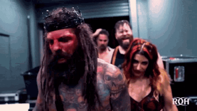 a group of wrestlers are standing next to each other in a room .