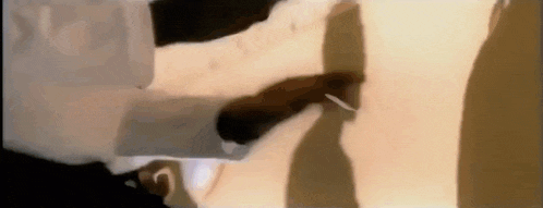 a close up of a person 's belly with a shadow of a person .