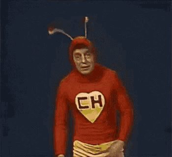 a man in a chapolin costume is standing in front of a sign that says " cuida bem dela "