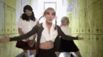a group of people are dancing together in a hallway .