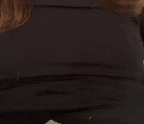 a close up of a person 's torso with a black shirt on