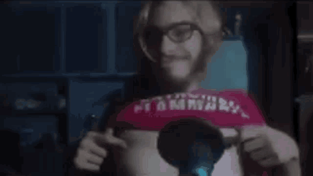 a man wearing glasses and a red shirt that says ' flammary ' on it