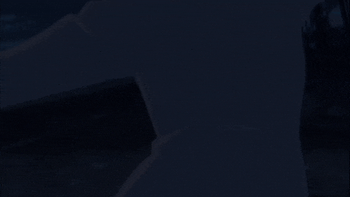 a woman with her arms outstretched is standing in the dark