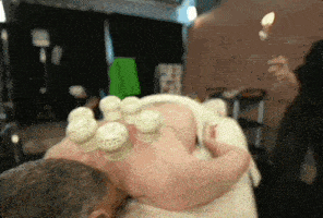a man is getting a massage with cups on his back .