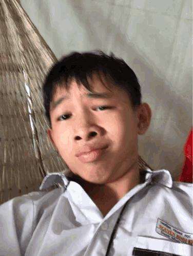a young boy wearing a white shirt with the name nguyen minh ki on it