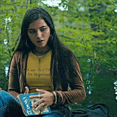 a girl wearing a t-shirt that says i eat math for breakfast