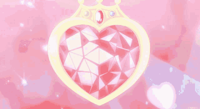 a heart shaped pendant with a crown on top of it