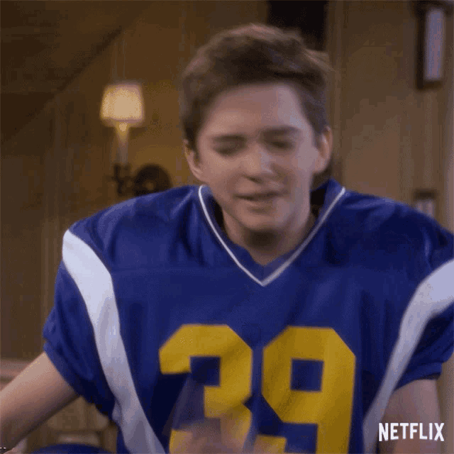 a man in a blue and white jersey with the number 39 on it