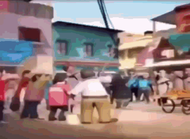a crowd of people are walking down a street in front of a building