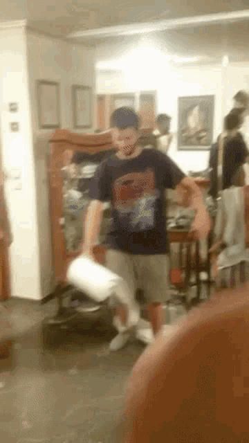 a man in a spiderman shirt is dancing