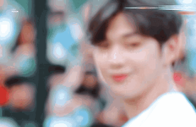 a close up of a person 's face with a blurry background