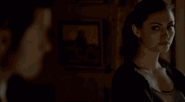 a woman looks at her reflection in a mirror