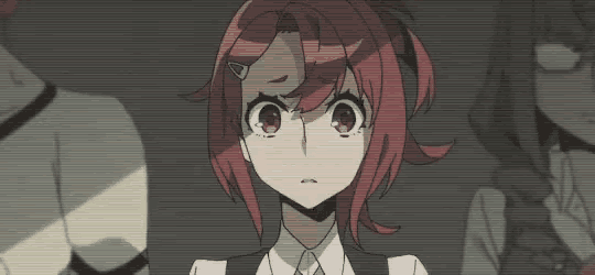 a girl with red hair is standing in front of a group of people and looking at the camera .
