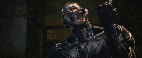 a close up of a robot shooting a red light .