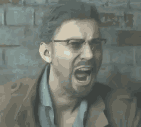 a man wearing glasses is making a funny face .