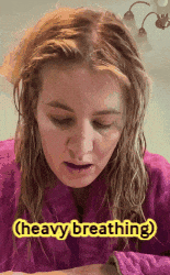 a woman is wearing a pink robe and says heavy breathing