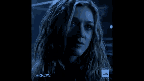 a close up of a woman 's face with the word arrow behind her