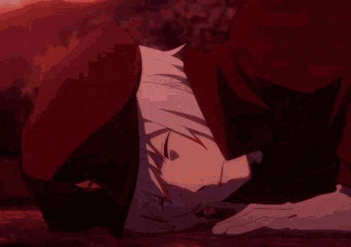 a close up of a person laying on the ground with their head down