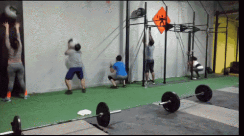 a group of people are doing exercises in a gym with a sign on the wall that says ' x '