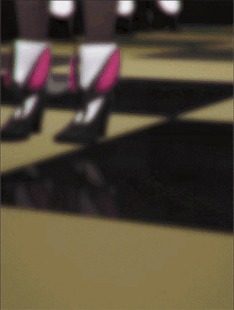 a blurry picture of a person 's feet on a checkerboard floor