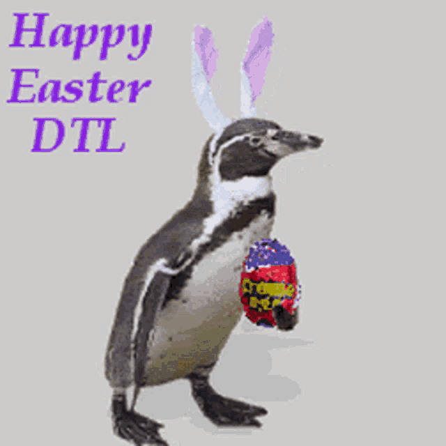 a penguin is wearing bunny ears and holding an easter egg