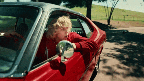 a man in a red car with the number 1 on the side