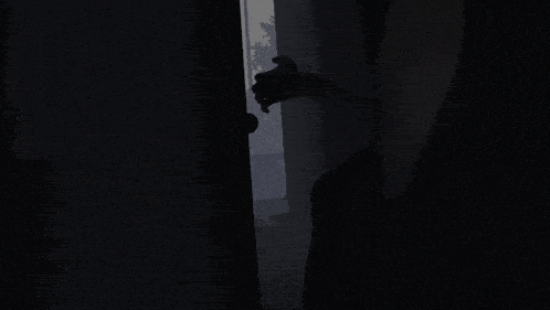 a silhouette of a person holding a teddy bear in front of a sign that says ' a ' on it