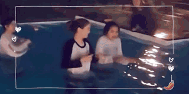 a group of people are swimming in a pool and laughing .