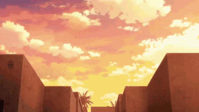 a sunset over a row of buildings with palm trees in the background