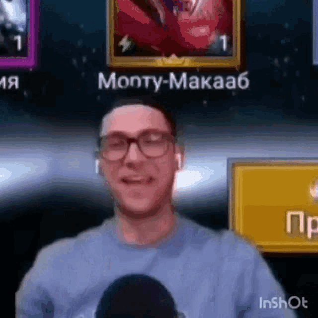 a man wearing glasses and ear buds is smiling in front of a screen that says monty-makaab .