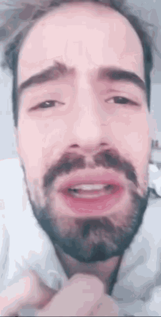 a close up of a man 's face with a beard