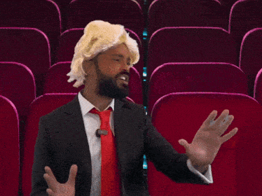 a man in a suit and tie with a trump wig on