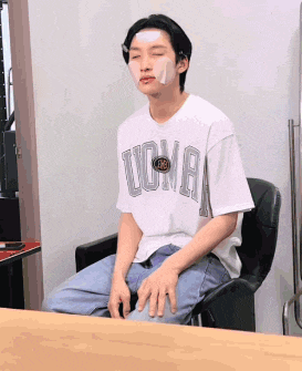 a young man with a bandage on his forehead is wearing a ucla shirt