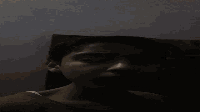 a person laying down with their eyes closed