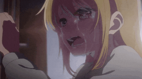 a girl with blonde hair is crying with her eyes closed