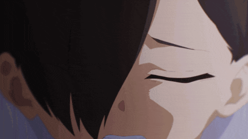 a close up of a person 's face with black hair