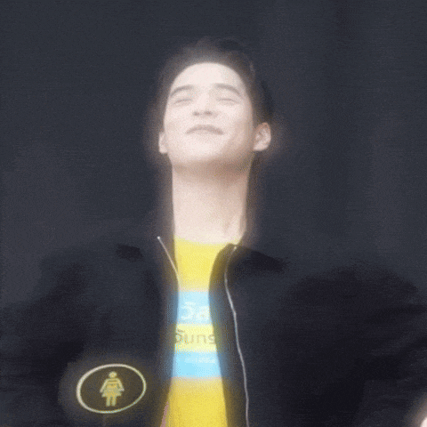 a man wearing a black jacket and a yellow shirt with a woman 's symbol on it
