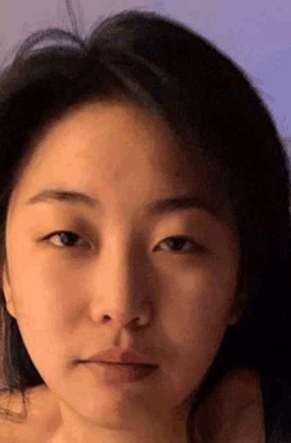 a close up of a woman 's face with her eyes closed .