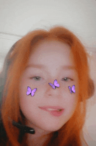 a girl with purple butterflies on her face