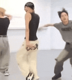 a group of people are dancing in a room and one of them is wearing a shirt that says abercrombie