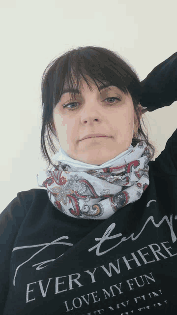 a woman wearing a black shirt that says " every where love my fun " on it