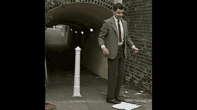 a man in a suit and tie is dancing on a piece of paper .