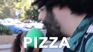 a man with a beard is holding a green ball with the word pizza written on it