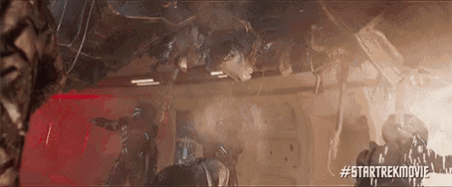 a group of people are standing in a room with a lot of smoke coming out of it .