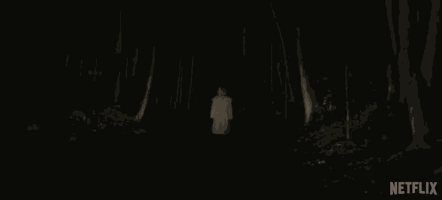 a woman is wearing a fur coat in a dark room .