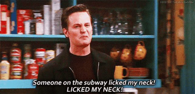 a man is standing in front of a shelf and saying someone on the subway licked my neck !