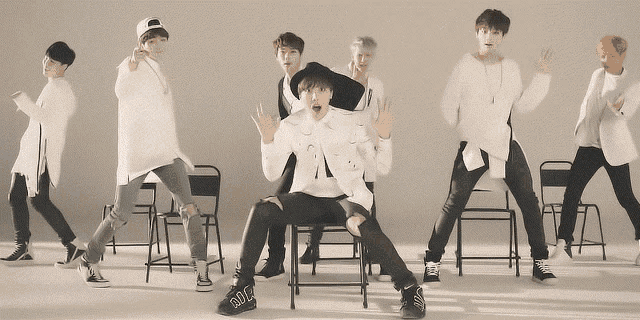 a group of young men are dancing and one of them is wearing a pair of shoes that say ' rm ' on them