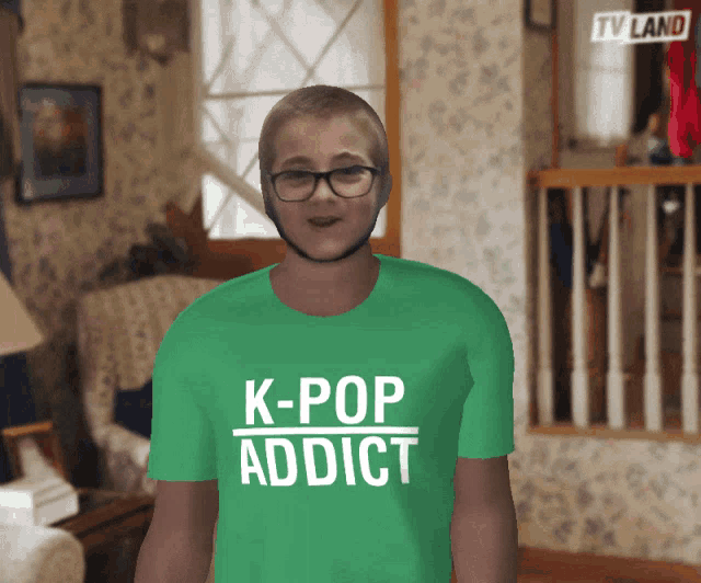 a young boy wearing a green shirt that says k-pop addict