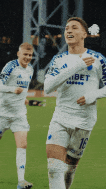 a soccer player wearing a white jersey with the number 16 on it